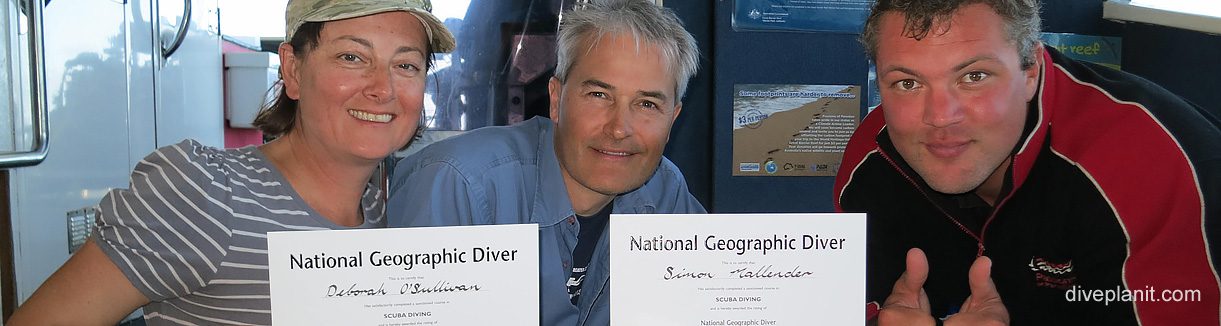 Receiving our national geographic diver certificates at paradise reef diving with passions of paradise banner