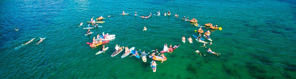 Paddle out team forms a heart in support of marine park sanctuaries fb diveplanit blog banner