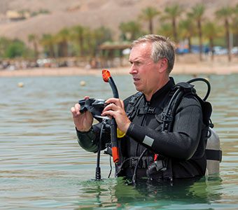 Diving and aging scuba diver shutterstock 1287265198 feature