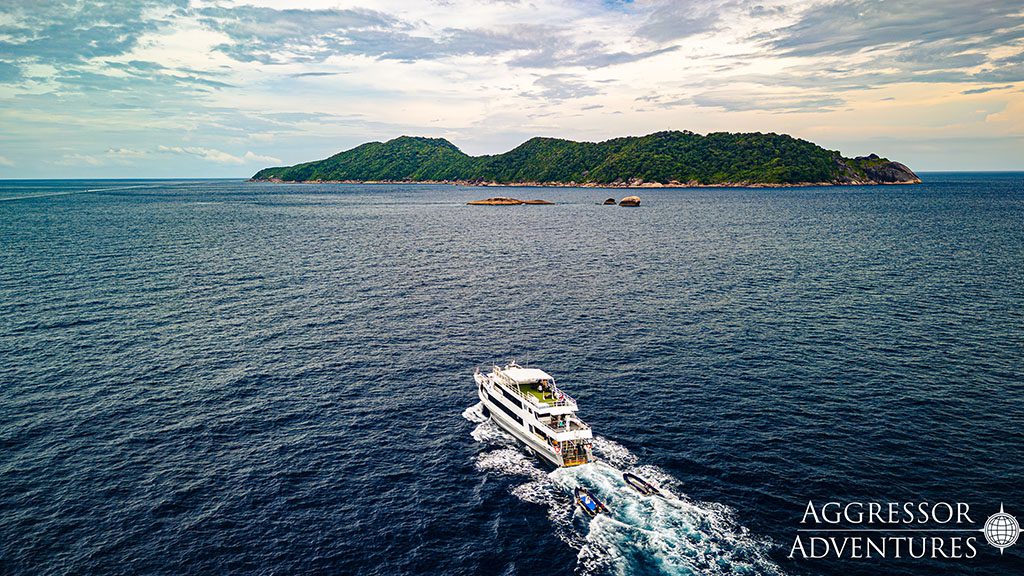 5 thailand aggressor liveaboard indonesia aerial boat back view with island